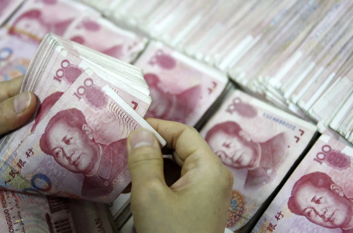 This picture taken on September 24, 2013 shows Chinese 100 yuan (RMB) bank notes being counted at a bank in Huaibei, in eastern China's Anhui province. According to Shanghai Security News US$212 billion left China during the period Oct. 1-27. (STR/AFP/Getty Images)