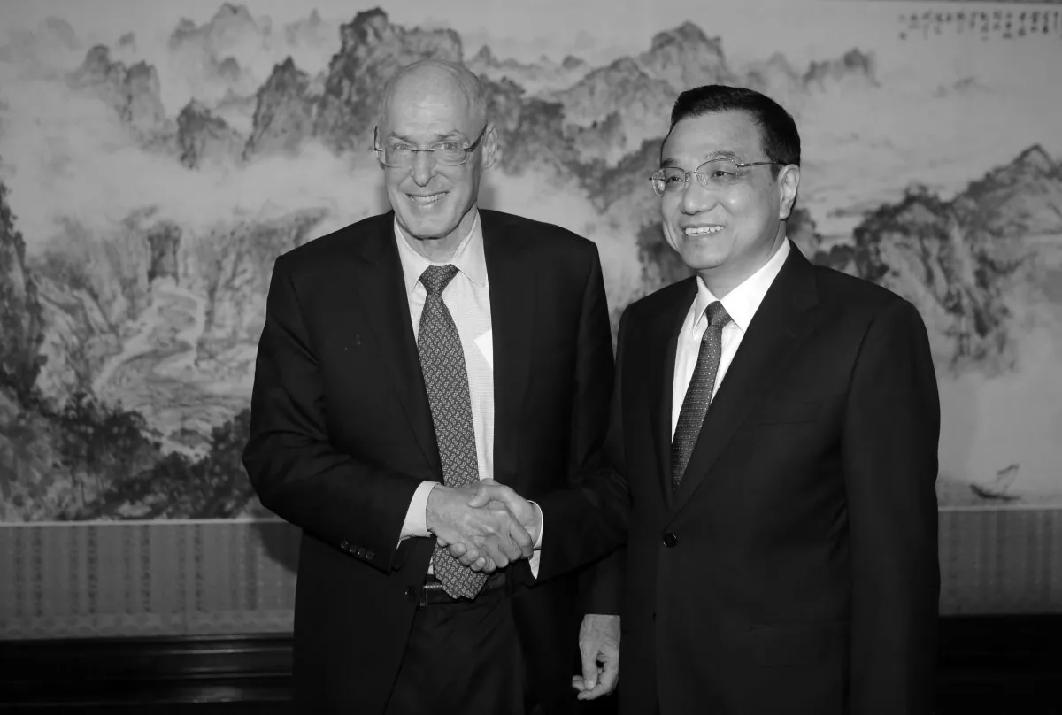 Former U.S. Treasury Secretary Henry Paulson (L) shakes hands with China's Premier Li Keqiang during a meeting at the Zhongnanhai compound on Nov. 7, 2013 in Beijing, China. In a recent opinion piece, Paulson asserted China's economy is back on track, a conclusion Chinese netizens mocked. (Jason Lee - Pool/Getty Images)