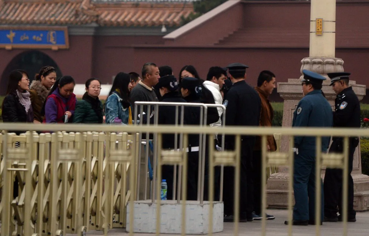 Chinese police check tourists entering Tiananmen Square as security is increased during the Communist Party Central Committee's Third Plenum in Beijing on Nov. 9, 2013. The four-day session takes place in a hotel in the capital's outskirts that in 1978 hosted the plenum that set the country on the path of Deng Xiaoping's economic reforms. (Mark Ralston/AFP/Getty Images)
