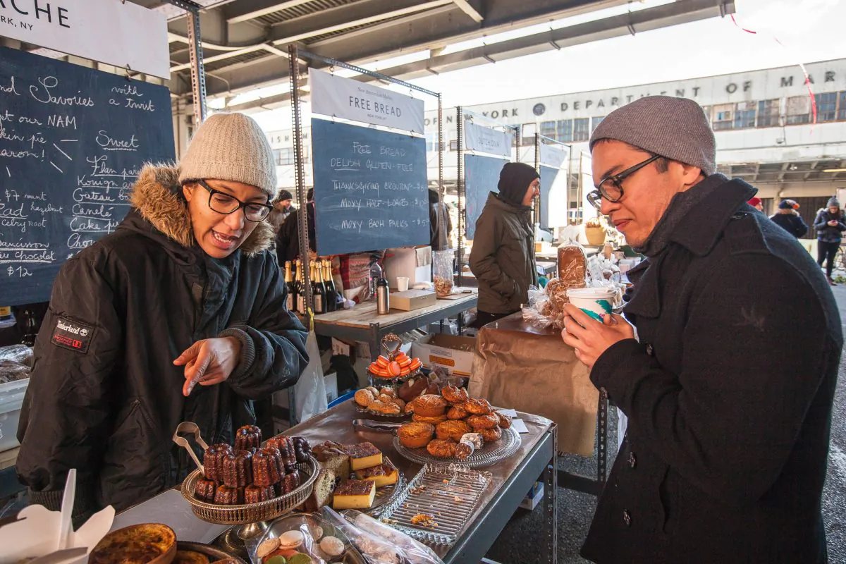 Vendor of Pistache NYC talks to a customer at the New Amsterdam Market, Lower Manhattan, New York, Nov. 24, 2013. (Petr Svab/Epoch Times)