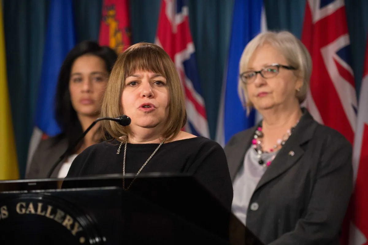 Professor, author, and anti-pornography activist Gail Dines describes the impacts of pornography on young people during a press conference on Parliament Hill Wednesday. Casandra Diamond (L) and MP Joy Smith look on. (Matthew Little/Epoch Times)