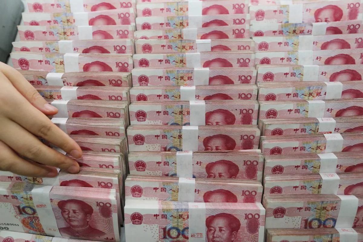 A teller counts yuan banknotes in a bank in Lianyungang, East China's Jiangsu province on August 11, 2015. Donald Trump and his advisors have for a long time accused China to be an unfair trader and currency manipulator.  (STR/AFP/Getty Image)