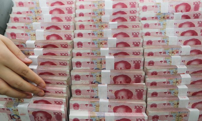 A teller counts yuan banknotes in a bank in Lianyungang, East China's Jiangsu province on August 11, 2015. Donald Trump and his advisors have for a long time accused China to be an unfair trader and currency manipulator.  (STR/AFP/Getty Image)