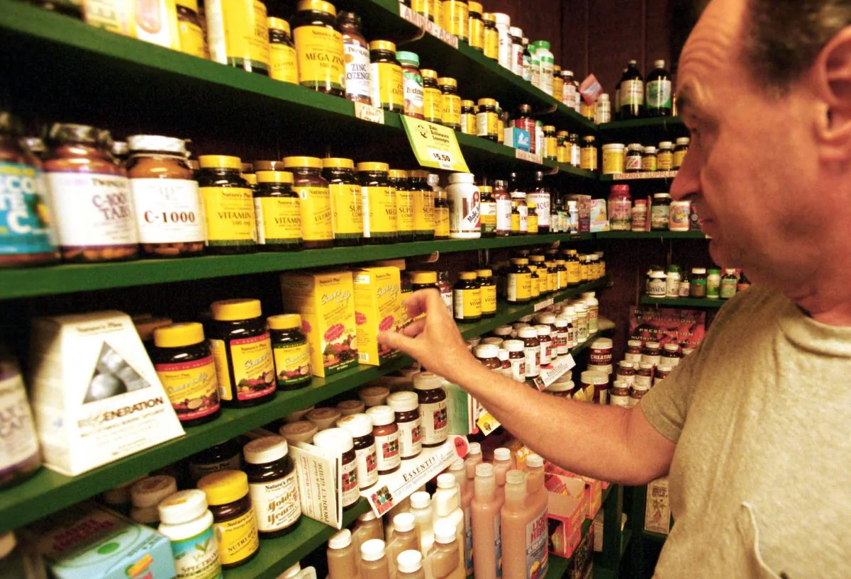 A customer looks at vitamins at Green Street Natural Foods in Melrose, Mass., on July 10, 2001. (Darren McCollester/Getty Images)