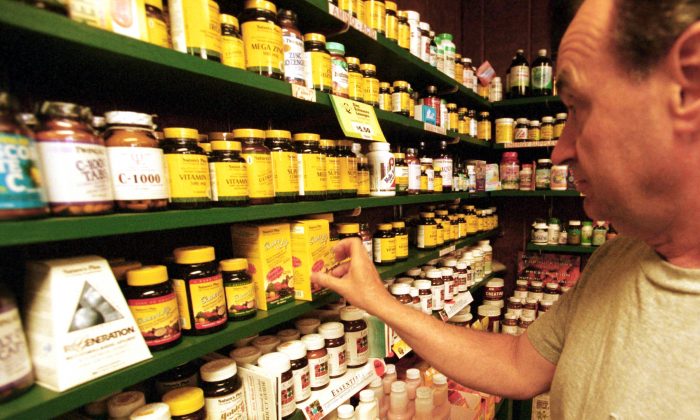 A customer looks at vitamins at Green Street Natural Foods in Melrose, Mass., on July 10, 2001. (Darren McCollester/Getty Images)