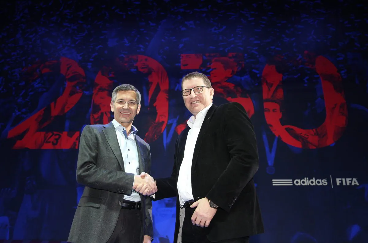 Adidas Group CEO Herbert Hainer (L) and FIFA Marketing Director Thierry Weil shake hands at the Russia National Team World Cup Presentation in Moscow, Nov. 21. (Kristina Nikishina/Getty Images)