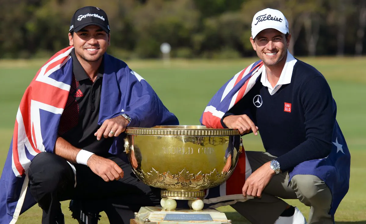 Jason Day (L) and Adam Scott (R) of Australia pose with the trophy after winning the team event of the Golf World Cup tournament played at the Royal Melbourne course in Melbourne, on Nov. 24, 2013. (William West/AFP/Getty Images)