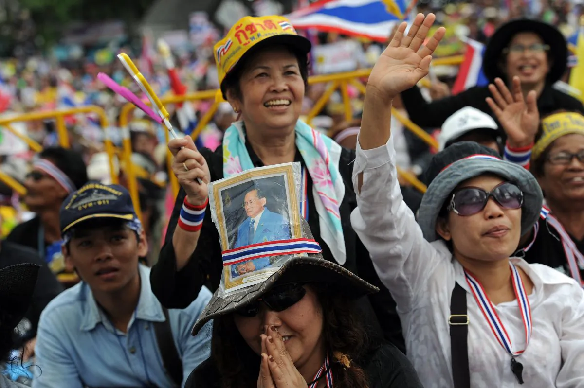 A Thai opposition protester with a picture of King Bhumibol Adulyadej takes part in a rally at the Democracy Monument in Bangkok, Nov. 24. (Christophe Archambault/AFP/Getty Images) 