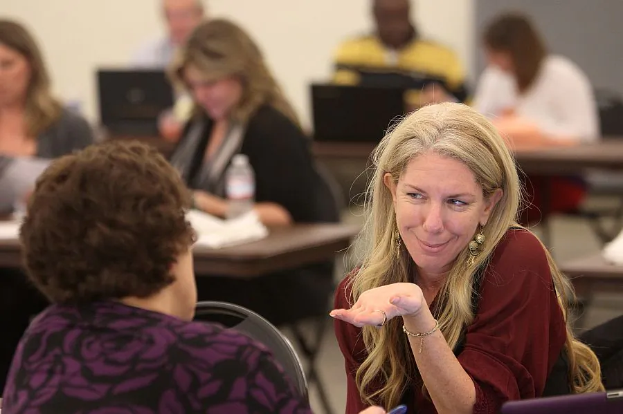 Health care reform specialist Naama Pozniak helps a woman compare plans at the free Affordable Care Act (ACA) Enrollment Fair at Pasadena City College on Nov. 19 in Pasadena, Calif. (David McNew/Getty Images)