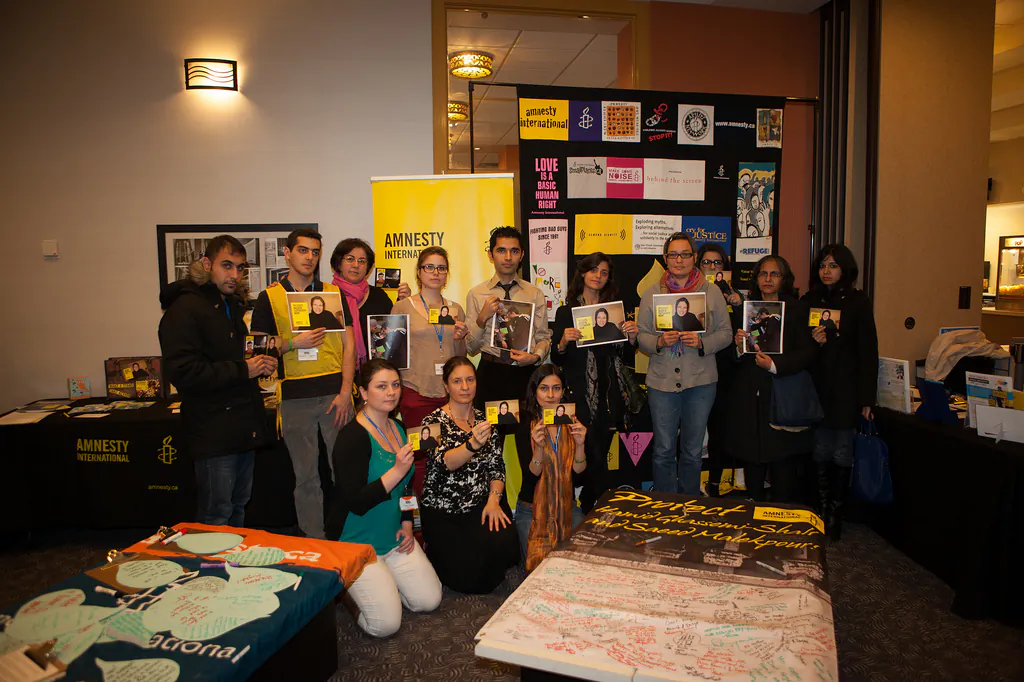 2012 Reel Awareness Film Festival organizers alongside other Amnesty International members hold a picture of Iranian human rights lawyer Nasrin Sotoudeh who was imprisoned in Iran for her work as a lawyer. Sotoudeh was released this September alongside other political prisoners. (Eugen-Florin Zamfirescu)