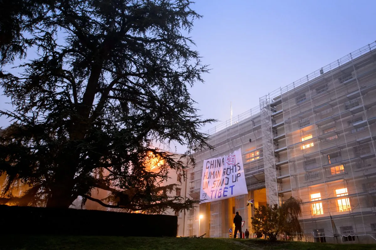 Tibetan activists unfold a giant banner during a demonstration on a building of the United Nations offices in Geneva, Oct. 22, 2013. China underwent a widely anticipated United Nations review of its human rights record. (Fabrice Coffrini/AFP/Getty Images)