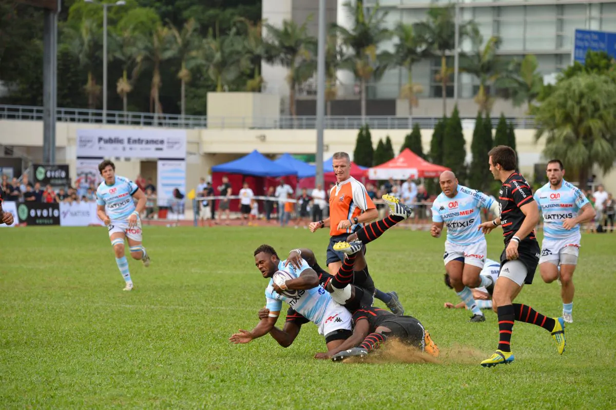 Two Toulouse players tackle Racing Metro 92 attacker during the Natixis Cup Hong Kong 2013 match between Top French Rugby clubs Toulouse and Racing Metro 92 at Aberdeen Stadium on Saturday Nov 9, 2013. Toulouse won the game 19-12. (Bill Cox/Epoch Times)