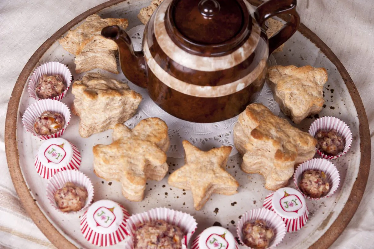 A platter of Whole Wheat Biscuits and Cranberry-Walnut Butter surround a pot of tea. (Cat Rooney/Epoch Times)