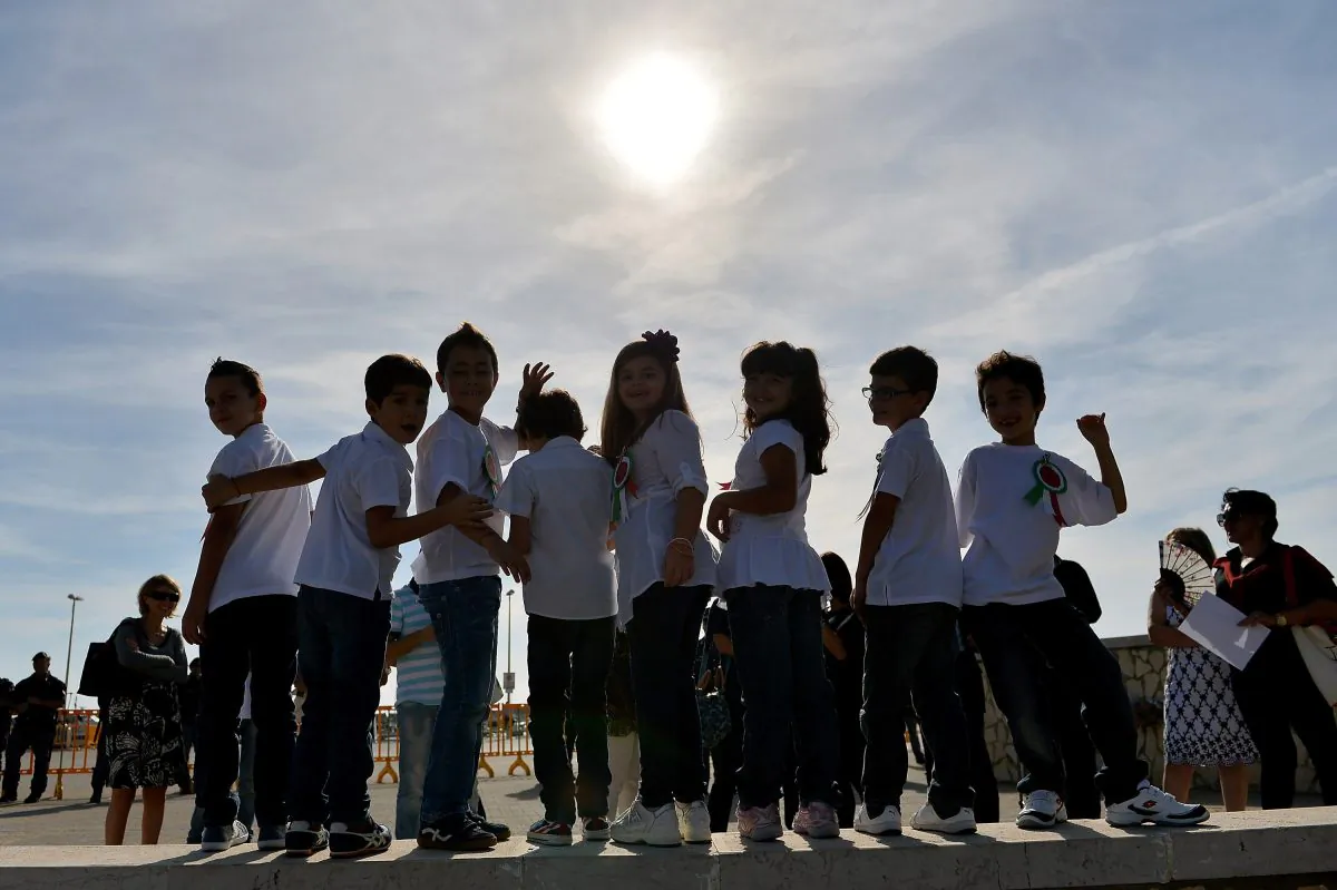 Italian elementary students attend the commemoration ceremony for the victims of the boat sinking disaster off the Lampedusa coast on Oct. 21, in San Leone near Agrigento, Italy. The disaster killed more than 300 asylum seekers. (Tullio M. Puglia/Getty Images)