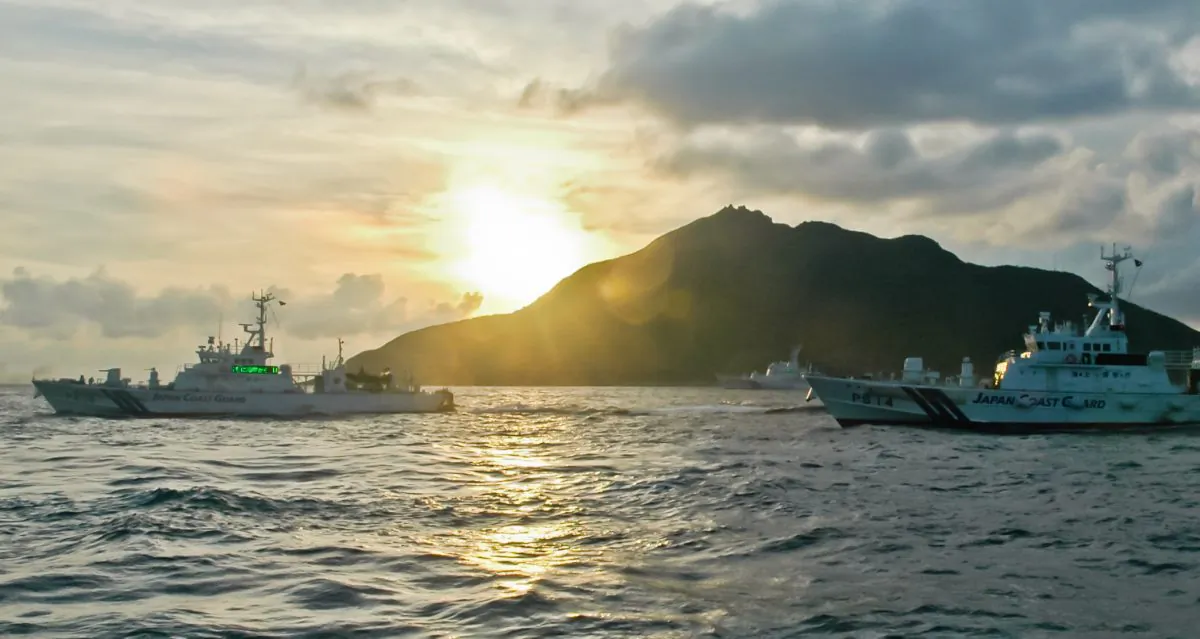 Japanese Coast Guard ships are seen from a Chinese ship near the Senkaku Islands in the East China Sea Aug. 18. China recently established an air defense zone, which encompassed the islands, and the United States wants Chinese leaders to explain why. (AP Photo/Emily Wang)