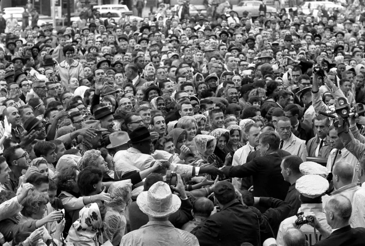President Kennedy reaches out to the crowd gathered at the Hotel Texas Parking Lot Rally in Fort Worth, TX, 22 November 1963.  (Cecil Stoughton. White House Photographs. John F. Kennedy Presidential Library and Museum, Boston)
