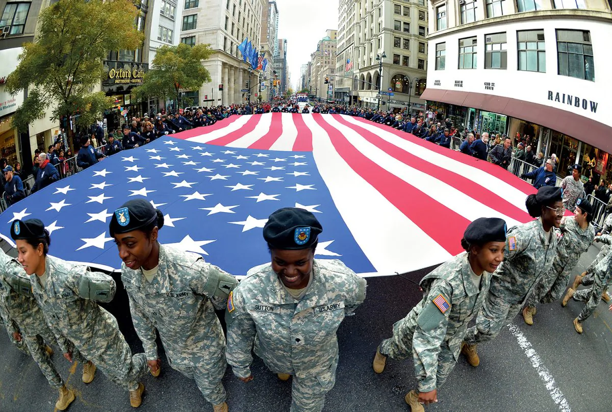 Members of the New York National Guard carry a large flag during the annual Veterans Day parade on Fifth Avenue in Manhattan, New York, Nov. 11, 2013. The parade honored all veterans with a special salute to women in uniform. (Stan Honda/AFP/Getty Images)