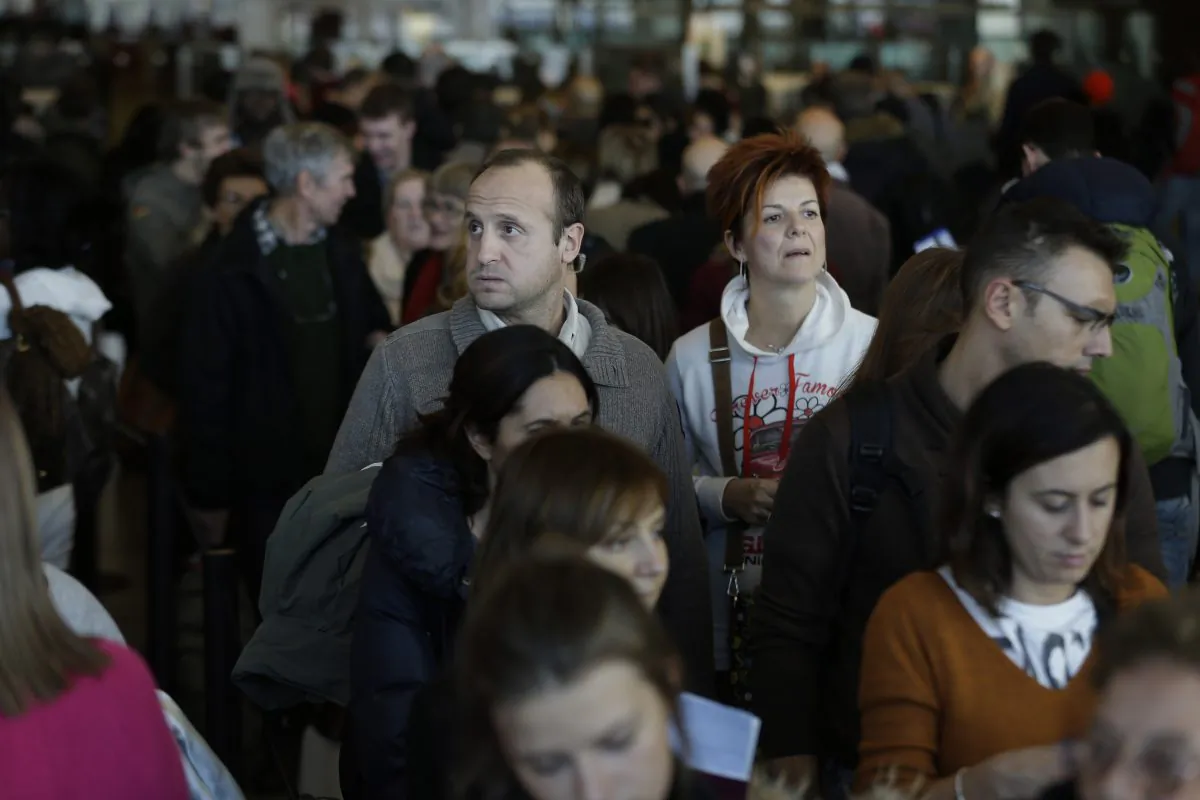 Travelers wait in a winding line to pass through customs and border control at John F. Kennedy International Airport in New York, Monday, Nov. 25, 2013. (AP Photo/Seth Wenig)