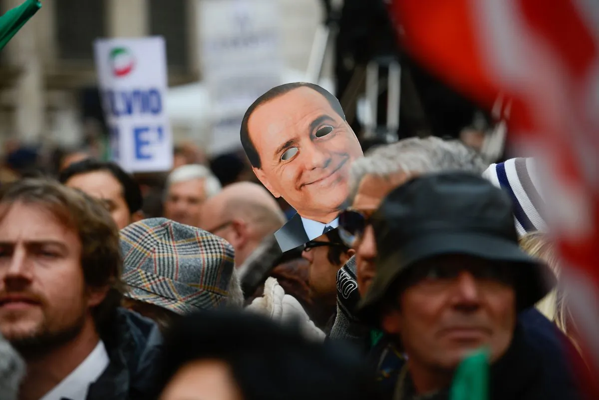 Supporters hold a mask of Silvio Berlusconi during a rally in support of former Italian Prime Minister in front of his house, Palazzo Grazioli, in Rome, Italy, on Nov. 27, 2013. The Italian Senate has today voted to expel former Prime Minister Silvio Berlsuconi from parliament after his recent conviction over tax fraud. (Giorgio Cosulich/Getty Images)