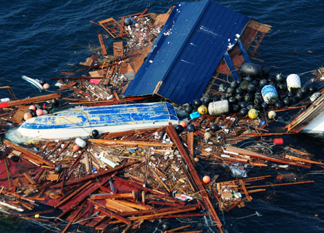An aerial view of debris from an 8.9 magnitude earthquake and subsequent tsunami that struck northern Japan. The debris was inspected by a helicopter-based search and rescue team from the aircraft carrier USS Ronald Reagan (CVN 76). Ships and aircraft from the Ronald Reagan Carrier Strike Group are searching for survivors in the coastal waters near Sendai, Japan. (U.S. Navy)