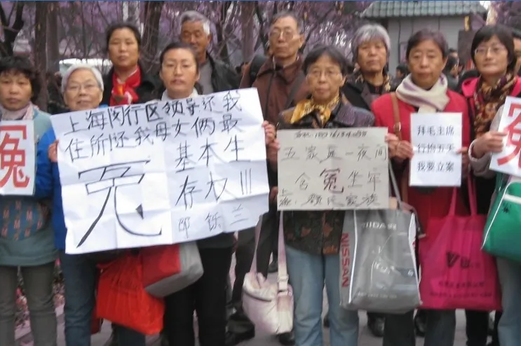Chinese petitioners protest in front of the Jingxi Hotel in Beijing, holding banners saying "Injustice", "Give us the basic right to live!" etc. on Nov. 9, 2013. The Third Plenum of the Chinese Communist Party Central Committee opened on Nov. 9 in Beijing, and thousands of petitioners protested at various politically sensitive places in the city. (Epoch Times)