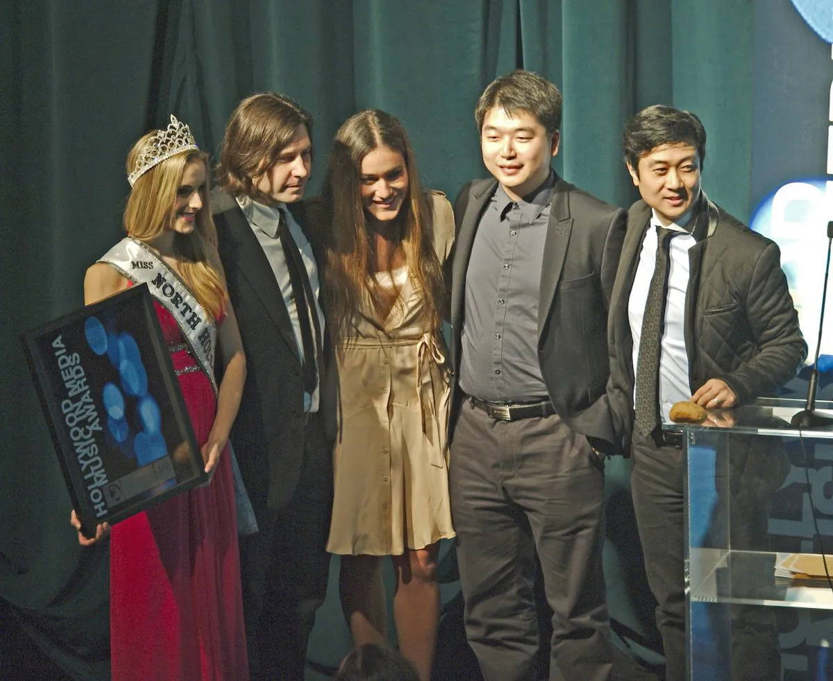 The "Free China" team accepts the HMMA theme song award for “The Courage to Believe.” (L-R) Miss North Hollywood Teen Mckenzie Seagren holding award, Kevin Dippold, Q'orianka Kilcher, Tony Chen, and Kean Wong. (Robin Kemker/Epoch Times)