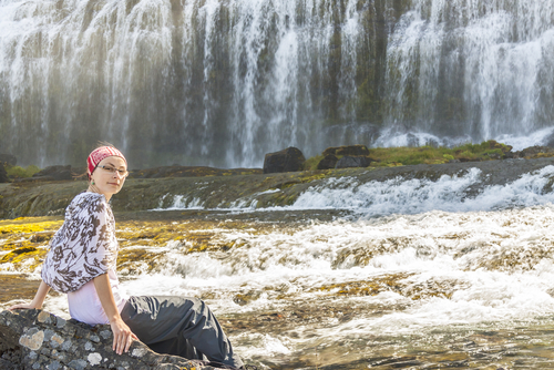 A woman sits near the Dynjandi waterfall in Westfjords, Iceland. Iceland is the best place to be a woman, according to a November 2013 article by Ice News. (Shutterstock*)