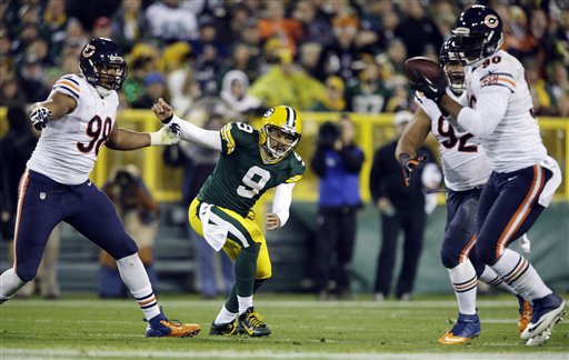Green Bay Packers quarterback Seneca Wallace watches as Chicago Bears' Julius Peppers (90) intercepts a pass during the first half of an NFL football game Monday, Nov. 4, 2013, in Green Bay, Wis. (AP Photo/Jeffrey Phelps)