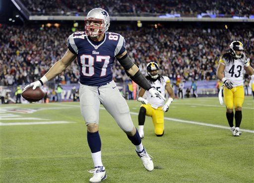 New England Patriots tight end Rob Gronkowski celebrates his touchdown catch in front of Pittsburgh Steelers safeties Ryan Clark, back left, and Troy Polamalu (43) during the second quarter of an NFL football game Sunday, Nov. 3, 2013, in Foxborough, Mass. (AP Photo/Charles Krupa)