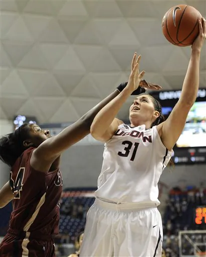 Connecticut's Stefanie Dolson shoots as Gannon's Nettie Blake, left, defends during the second half of an NCAA college exhibition basketball game, Friday, Nov. 1, 2013, in Storrs, Conn. Connecticut won 101-35. (AP Photo/Jessica Hill)