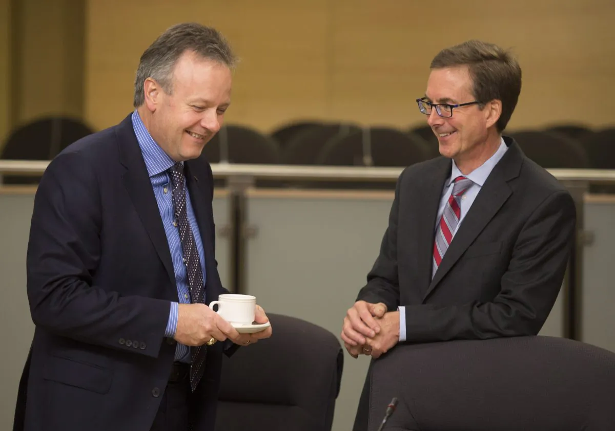 Governor of the Bank of Canada, Stephen Poloz, speaks with Deputy Governor Tiff Macklem as they wait to appear before the Senate Standing Committee on Banking, Trade and Commerce Wednesday, Nov. 20, 2013, in Ottawa. (The Canadian Press/Adrian Wyld)