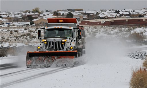 A truck plows snow in New Mexico on Nov. 24, 2013. (AP Photos/Albuquerque Journal, Jim Thompson)