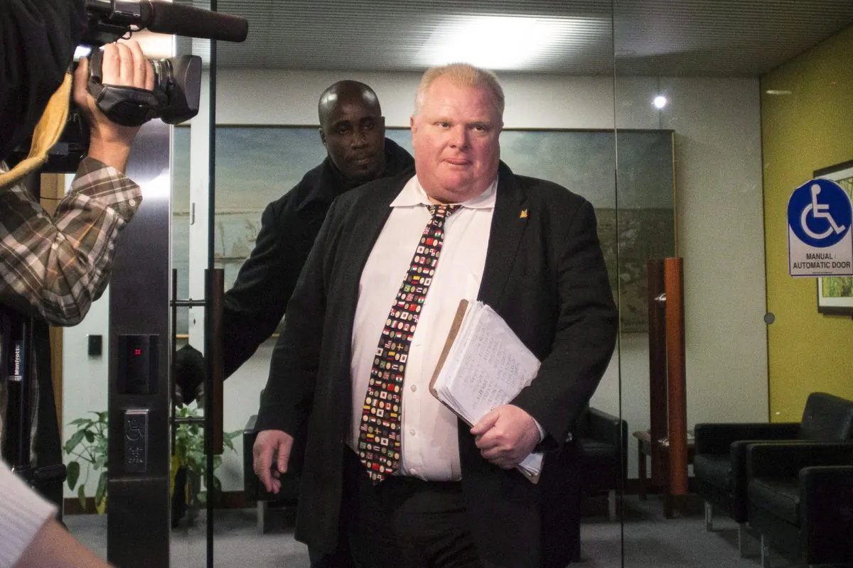 Mayor Rob Ford arrives at city hall in Toronto on Nov. 19, 2013. Newly released documents say police overheard alleged gang members on wiretaps talking about delivering drugs to Ford and having pictures of him using drugs, suggesting the images could be used for blackmail. (The Canadian Press/Chris Young)
