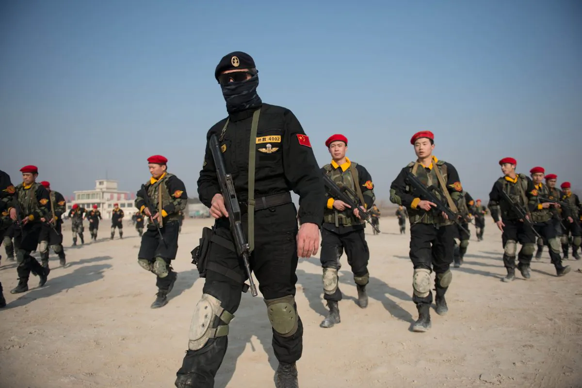 Trainee bodyguards of the Genghis Security Academy take part in an ambush exercise at an army training ground on the outskirts of Beijing on Jan. 18, 2013. Wei Jingsheng sees the sudden prominence of the bodyguard industry in China as a harbinger of social unrest. (Ed Jones/AFP/Getty Images)