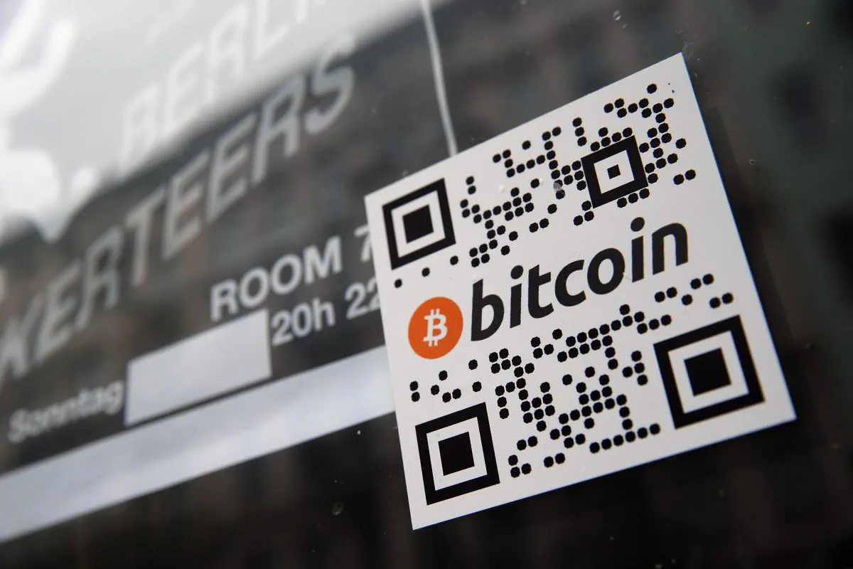 A sticker on the window of a local pub indicates the acceptance of bitcoins for payment on April 11, in Berlin, Germany. More than 1,000 brick and mortar businesses accept it, so do more than 10,000 online merchants. Why? Because its transaction costs are much lower than other forms of payment, such as credit cards. (Sean Gallup/Getty Images)