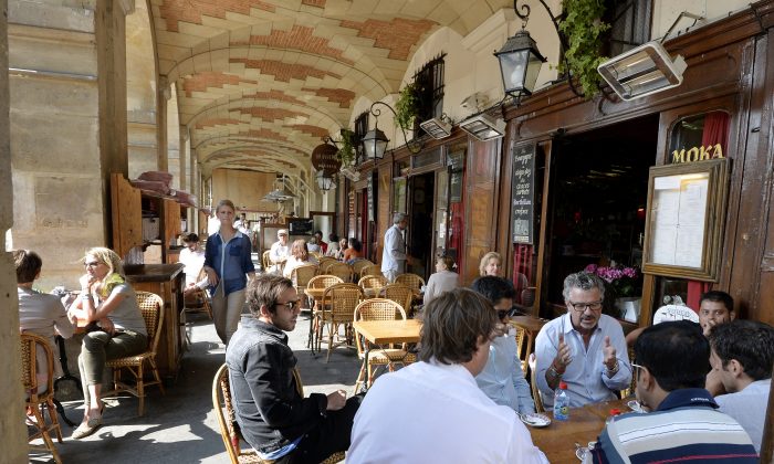 A photo taken on July 12, 2013 shows people on the terrace of a cafe on the Place des Vosges square in the Marais district in the 3rd and 4th arrondissements of Paris. (MIGUEL MEDINA/AFP/Getty Images)