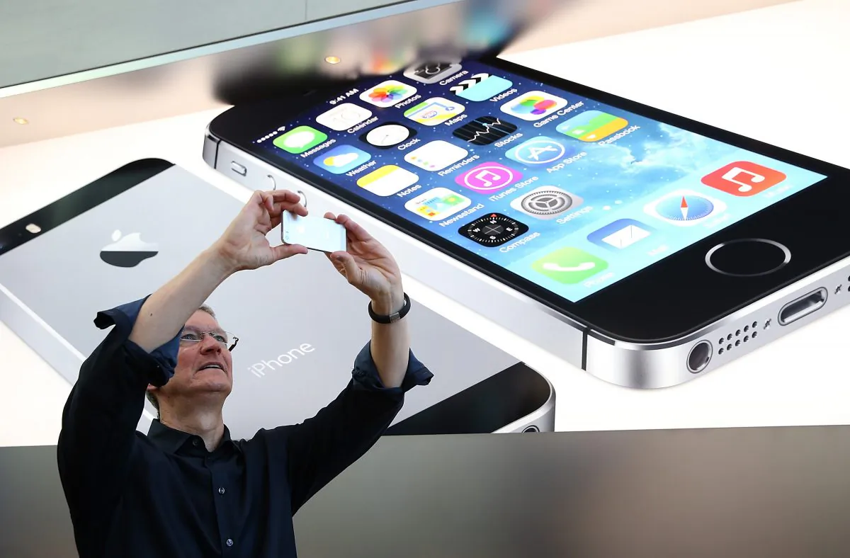 Apple CEO Tim Cook takes pictures in Palo Alto, Calif., Sept. 20 2013. Apple's iPhone 6 might feature a larger screen, according to rumors. (Justin Sullivan/Getty Images)