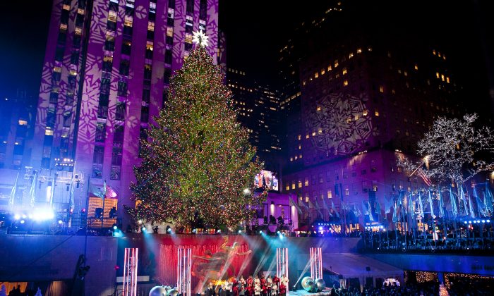 The 76-foot-tall tree is lit with 45,000 lights during the 81st Annual Rockefeller Center Christmas Tree Lighting Ceremony in New York on Dec. 4, 2013. This year, the Christmas tree will be an 85-foot, 13-ton Norway spruce. (Samira Bouaou/Epoch Times)