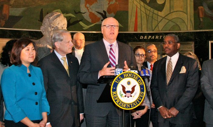 Rep. Joe Crowley (D-N.Y.) (C) with officials and supporters introduces the Silent Skies Act at the Marine Air Terminal, LaGuardia Airport, Queens, New York, Dec. 6, 2013 (Epoch Times)