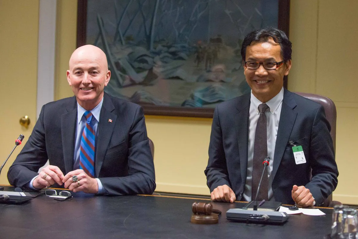 Conservative MP David Sweet sits with the Dalai Lama's new representative for North America, Kaydor Aukatsang, before a meeting about Tibet on Parliament Hill Dec. 4, 2013. (Matthew Little/Epoch Times)