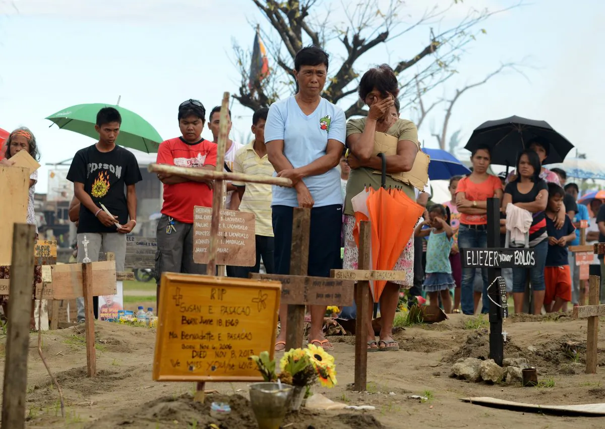 Relatives of victims of Tyhpoon Haiyan gather at a mass grave in Palo, Leyte, on Dec. 8, 2013 to commemorate one month since the typhoon.  (Noel Celis/AFP/Getty Images) 