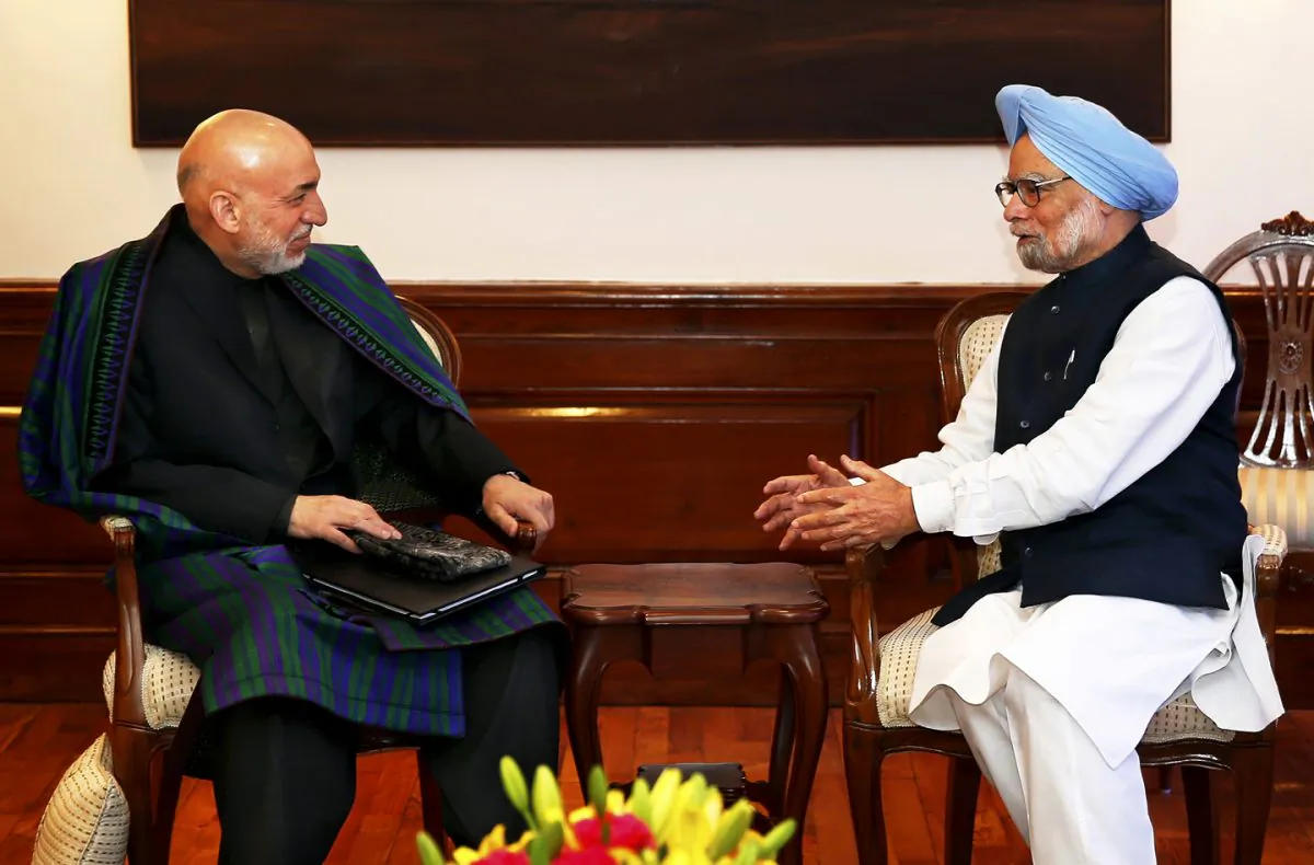 Indian Prime Minister Manmohan Singh (R) talks to Afghan President Hamid Karzai at his residence in New Delhi on December 13, 2013. Karzai was on a four-day official visit to India until December 15. India has promised more defense and security cooperation to Afghanistan. (Saurabh Das/AFP/Getty Images)