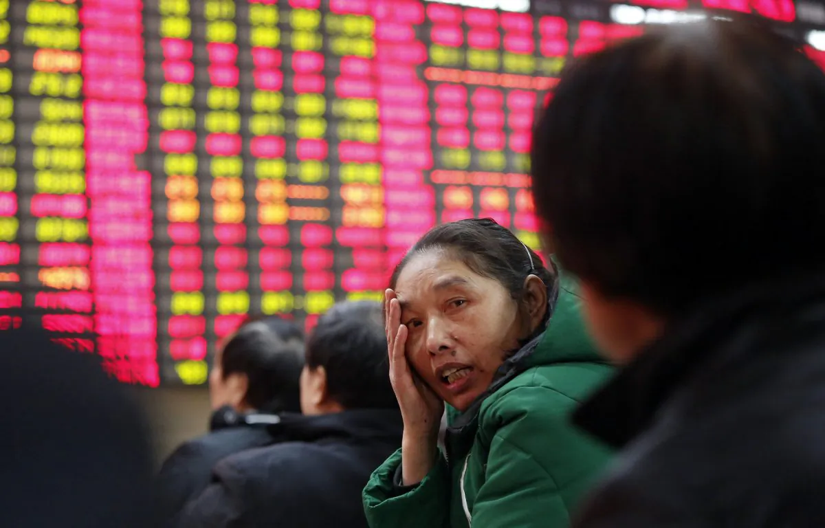 An investor chats with another at a private securities company on Tuesday, Dec. 24, 2013 in Shanghai, China. (AP Photo)