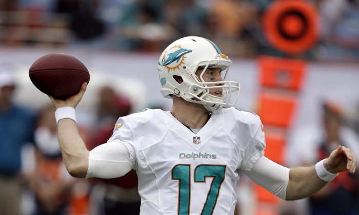 Miami Dolphins quarterback Ryan Tannehill (17) looks to pass during the second half of an NFL football game against the New England Patriots, Sunday, Dec. 15, 2013, in Miami Gardens, Fla. (AP Photo/Lynne Sladky)