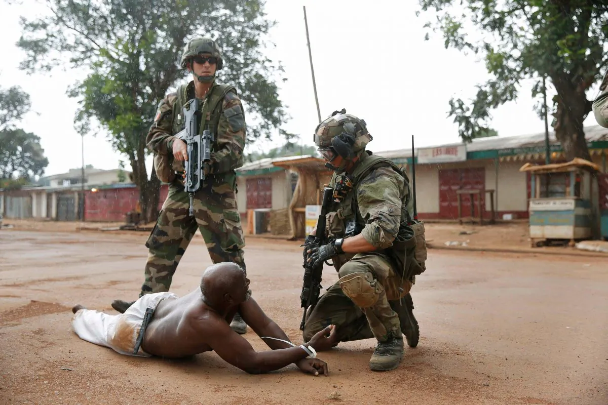 French troops detain a suspected Seleka officer, preventing Christian mobs from lynching him near in Bangui, Central African Republic, Dec. 9, 2013. (AP Photo/Jerome Delay) 