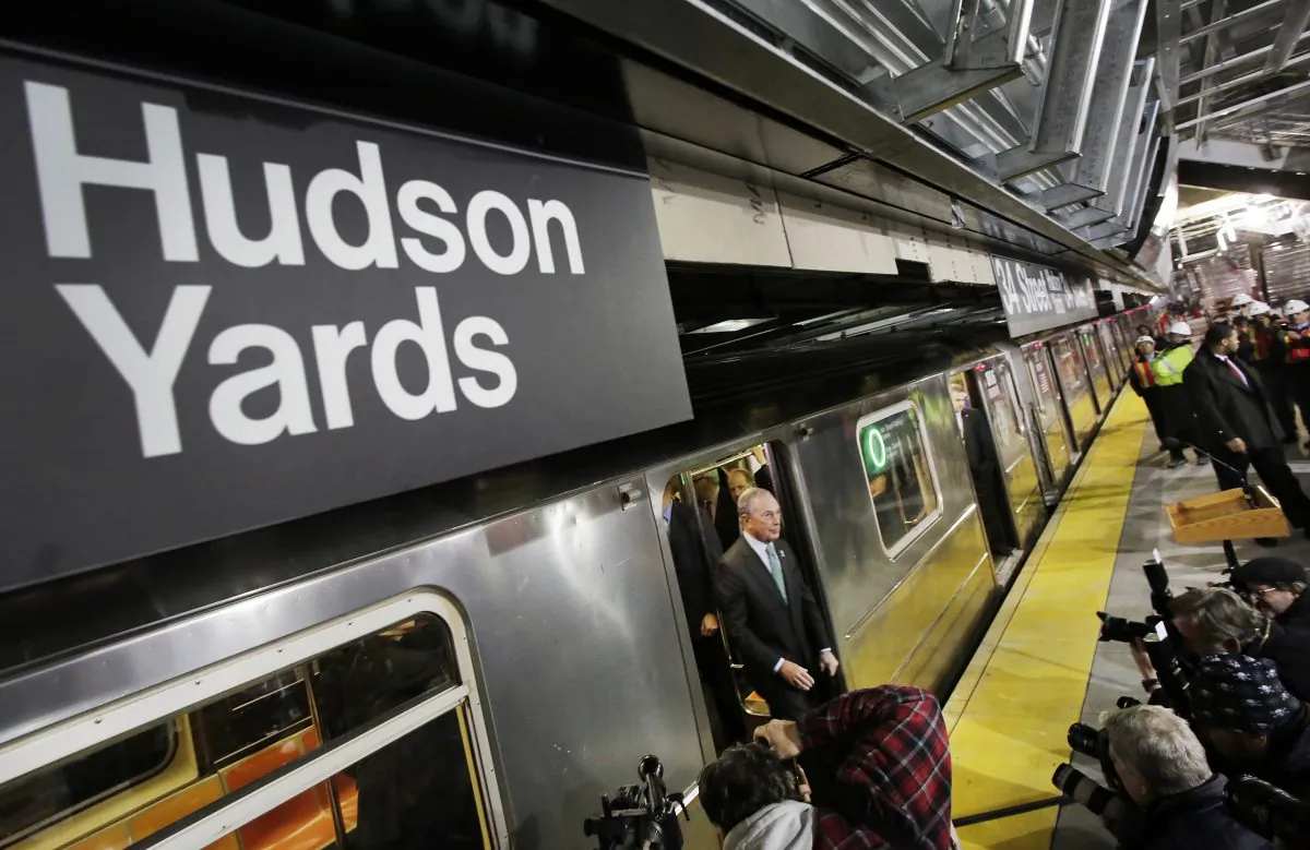 Mayor Michael Bloomberg steps from the 7 subway train into a news conference on the platform to discuss the extension of the line in New York on Dec. 20, 2013. (Mark Lennihan/AP)