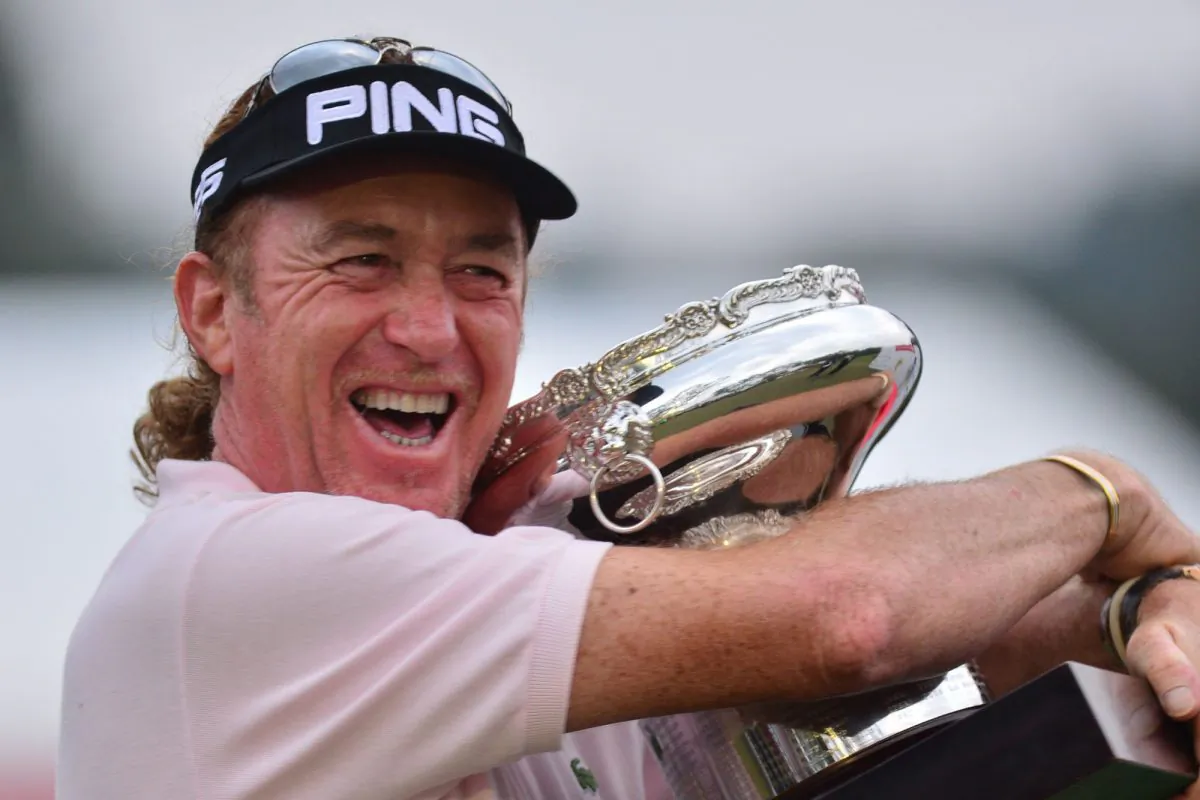 Miguel Angel Jimenez celebrates by hugging the Hong Kong Open Trophy after winning the tournament for the fourth time on Sunday Dec 8, 2013. (Eddie So)