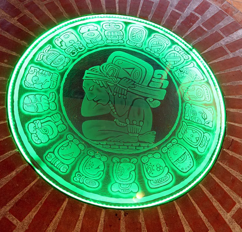 Set in the floor of Casa del Jade in Antigua is this Mayan calendar. Appropriately lighted with green. (Myriam Moran copyright 2013)