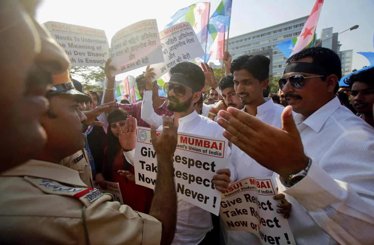 Indian policemen stop a group from the student wing of ruling Congress party, National Students Union of India (NSUI), during a protest outside the U.S. consulate in Mumbai, India, Friday, Dec. 20, 2013. India's information minister Manish Tewari lashed out at the United States on Friday and demanded an apology for the treatment and arrest of Devyani Khobragade, India's deputy consul general in New York, saying America cannot behave "atrociously" and get away with it. (AP Photo/Rafiq Maqbool)