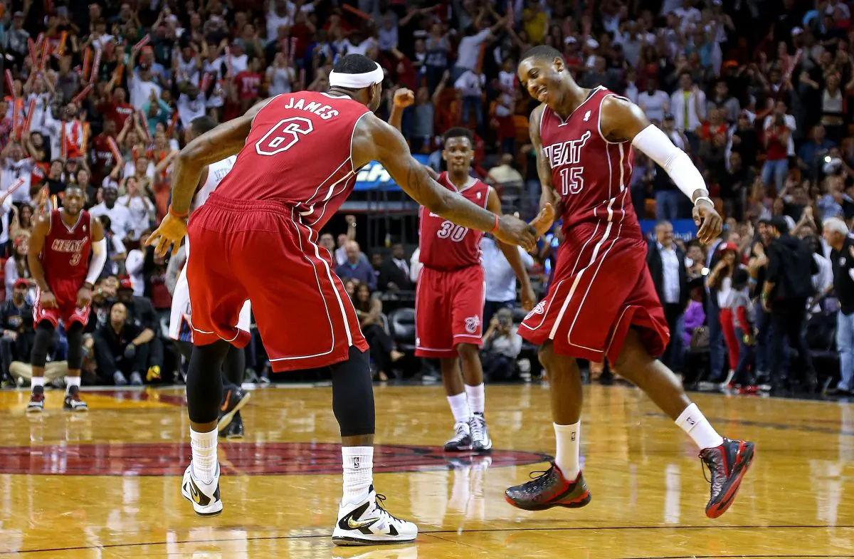  LeBron James #6 and Mario Chalmers #15 of the Miami Heat high five during a game against the Charlotte Bobcats at American Airlines Arena on December 1, 2013 in Miami, Florida. (Mike Ehrmann/Getty Images) 